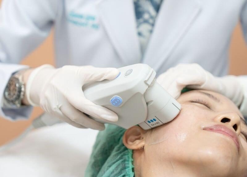 Woman undergoing HIFU treatment for a V-shaped facial contour