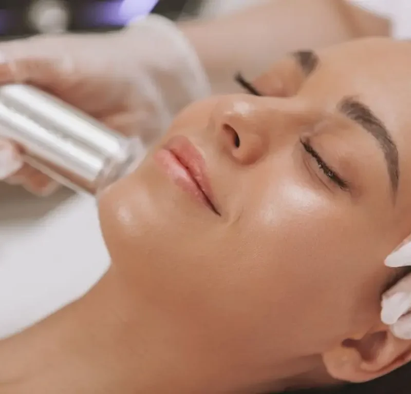 Woman with glowing youthful skin doing a collagen treatment