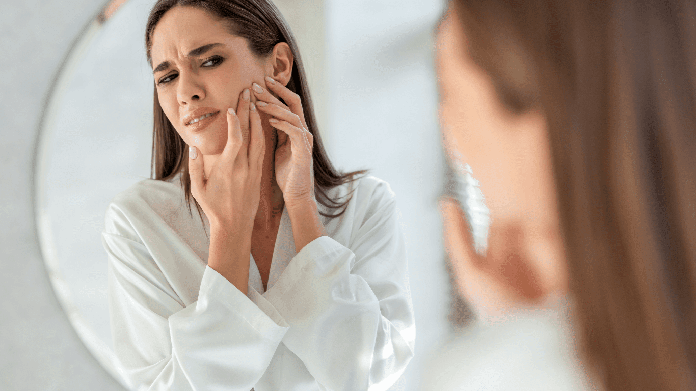 Woman looking frustrated with skincare routine