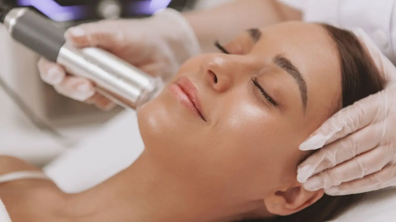 Woman with glowing youthful skin doing a collagen treatment